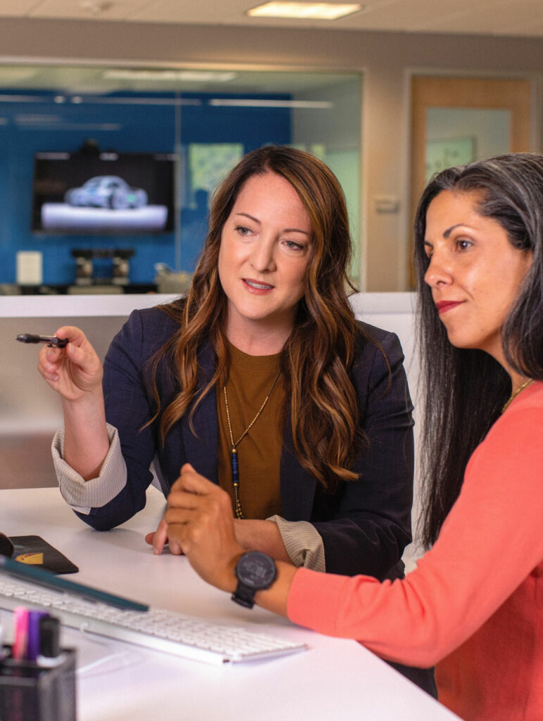 Two women sitting down having a meeting.